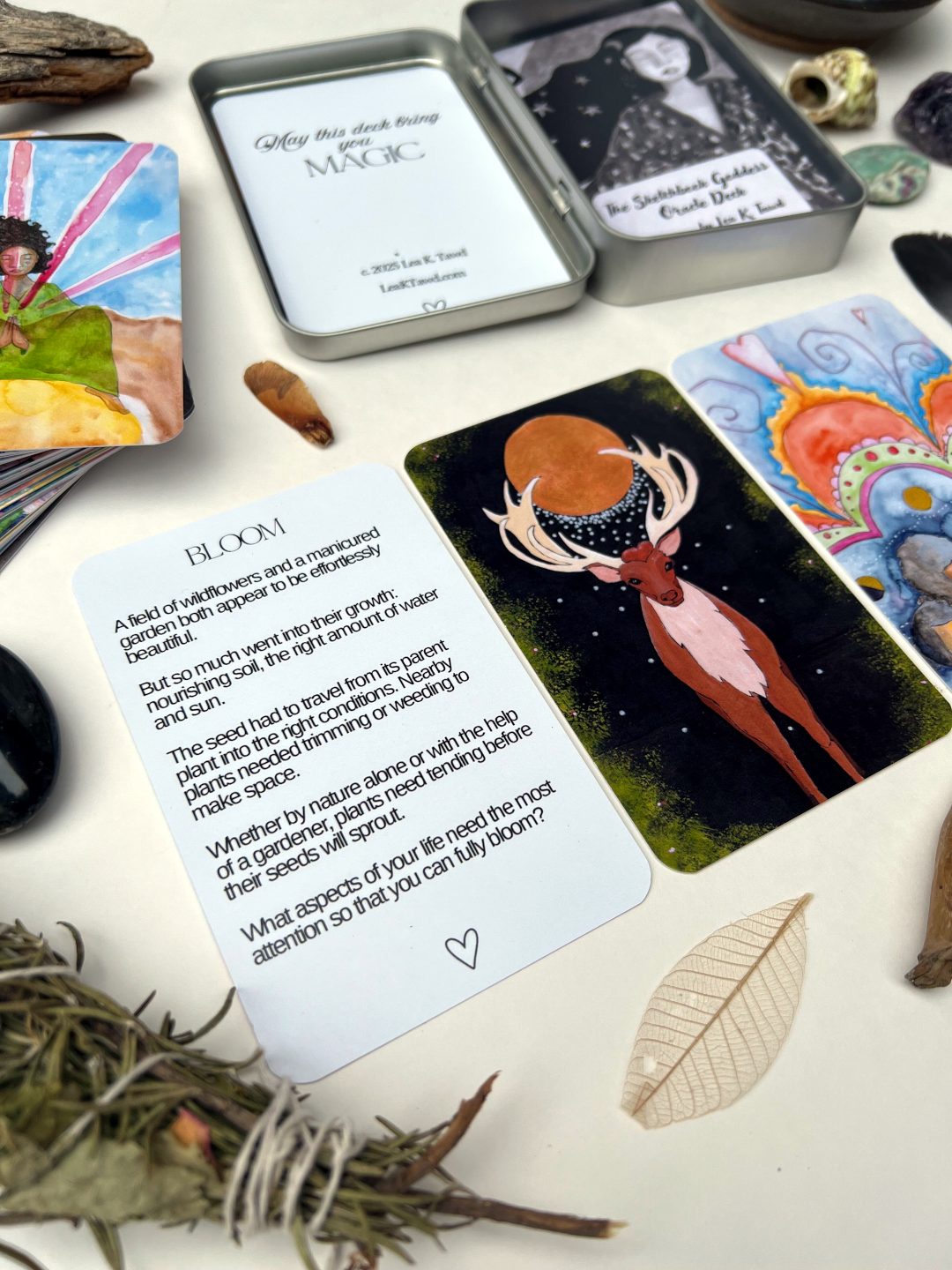 Oracle cards with mystical designs and text on a white surface with natural elements.